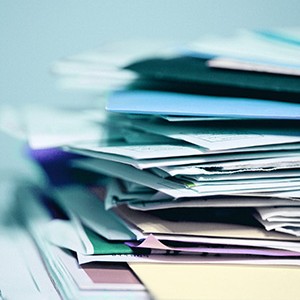 Papers and folders waiting for editorial attention.